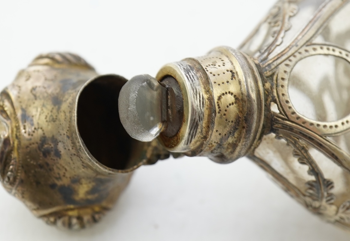 A late 19th century French parcel gilt white metal mounted and overlaid glass scent flask, with hinged cover and glass stopper